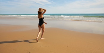 a sandy beach next to the ocean