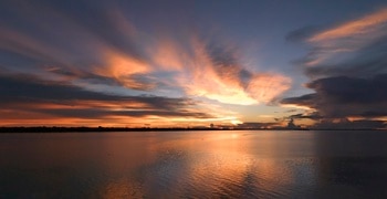 a sunset over a body of water