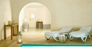 a living room filled with furniture and a mirror