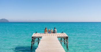 a chair sitting in front of a body of water