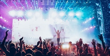 a crowd of people on a stage with a stage in the back