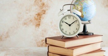 a clock on a stack of books