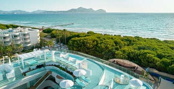 a resort with a beach and trees
