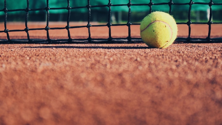 a person swinging a racket at a ball