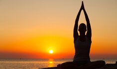 a person standing in front of a sunset