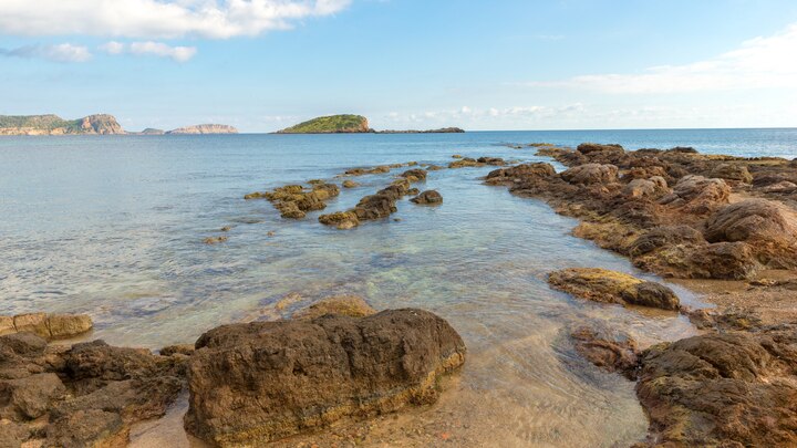 a rocky shore next to a body of water