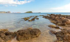 a rocky shore next to a body of water