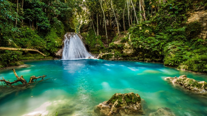a large waterfall and a pool of water