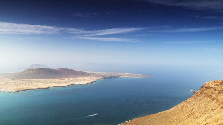 ein Gewässer mit einem Berg im Hintergrund